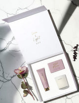The Wild flower Pamper Gift Box featuring a Living Light hand cream, soy candle, and card in a white magnetic box.