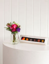 The Wild flower Sweet Petite gift set featuring a small fresh floral arrangement in a glass jar and handmade bonbons.