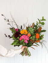 The Wild flower Florist Surprise bouquet featuring vibrant sunflowers, pink hydrangeas, and mixed seasonal foliage.