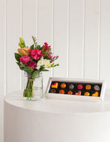 The Wild flower Sweet Petite gift set featuring a small fresh floral bouquet in a glass jar and handmade chocolates.