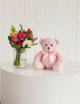 The Wild flower gift set featuring a fresh wildflower bouquet in a glass mason jar and a soft pink plush teddy bear.