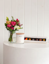 The Wild flower Scented Sweet Petite gift set featuring a fresh floral bouquet, Living Light candle, and chocolates.