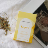 The Wild flower Kapow organic herbal tea box with loose leaf blend on white linen