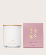 The Wild flower Living Light scented candle in a white glass jar with wooden lid and pink Pinot Noir gift box