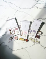 The Wild flower Pamper Gift Boxes featuring body bars, hand creams, and soy candles in three elegant fragrance sets.