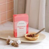 The Wild flower Libertine Blends Runaway Rose herbal tea box with loose tea leaves in a small bowl and tea bags.