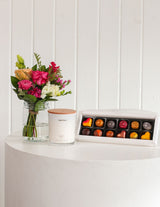 The Wild flower Scented Sweet Petite gift set featuring a fresh floral bouquet, Living Light candle, and chocolates.