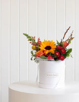 The Wild flower Wild Flower Box featuring a vibrant arrangement of sunflowers, roses, and seasonal blooms in a white box