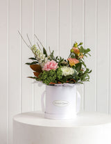 The Wild flower Wild Flower Box featuring seasonal pink roses, white blooms, and greenery in a white gift box.