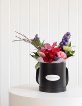 The Wild flower Wild Flower Box featuring a vibrant seasonal floral arrangement in a black gift box.