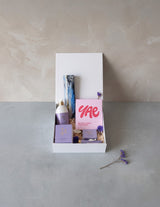 The Wild flower Treat Her wellness gift box featuring Living Light skincare, YAE face mask, and artisan chocolate.