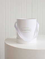 The Wild flower white Signature Wild Flower Hat Box with a ribbon handle for elegant floral bouquet presentation.